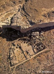 Low steep oblique aerial view of Pueblo Bonito in Chaco Canyon, New Mexico.