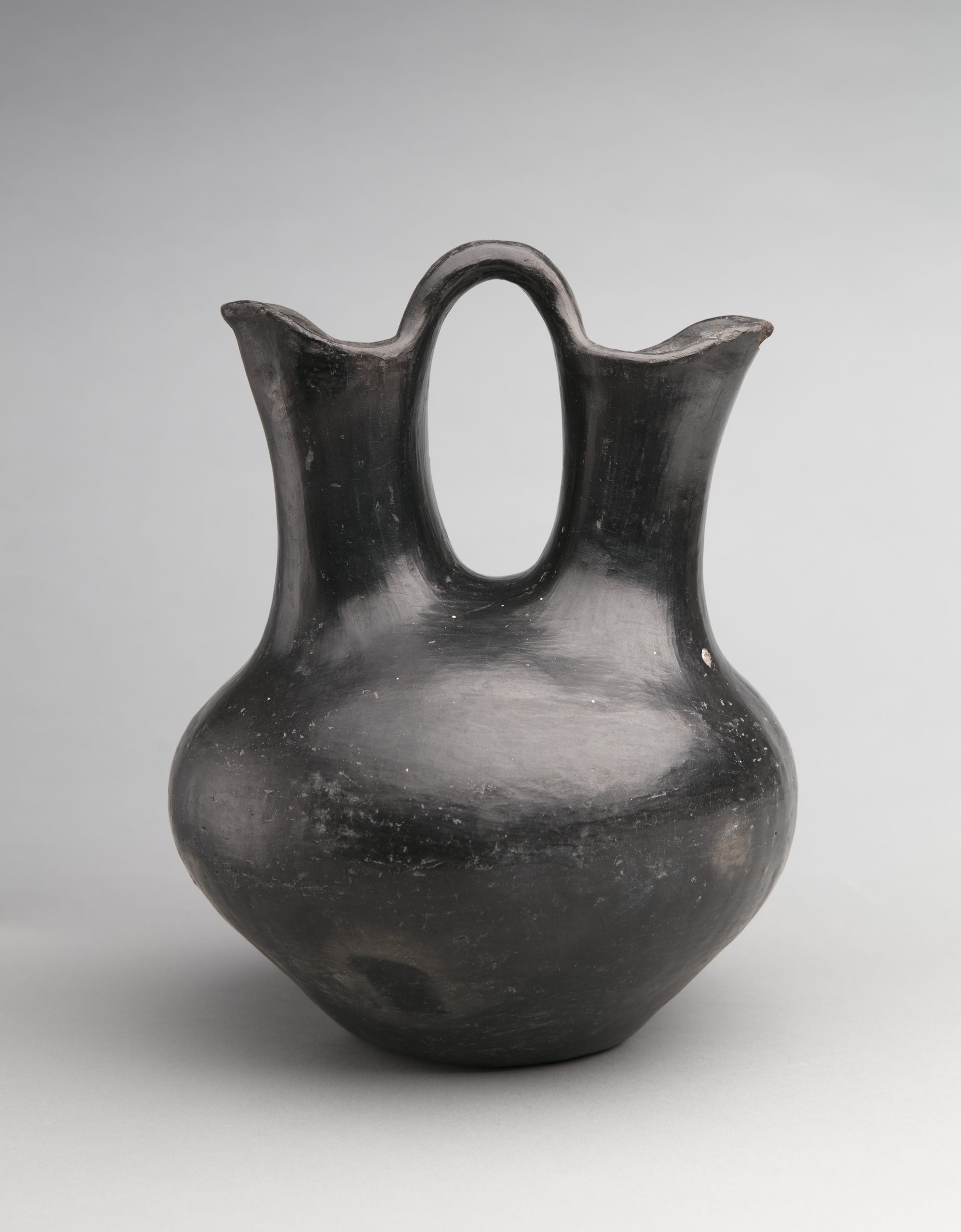 Wedding vase, Artist unknown (Santa Clara Pueblo), c. 1900, clay, 8” x 10 ½”. Cat. no. IAF.2140. Photo by Addison Doty.