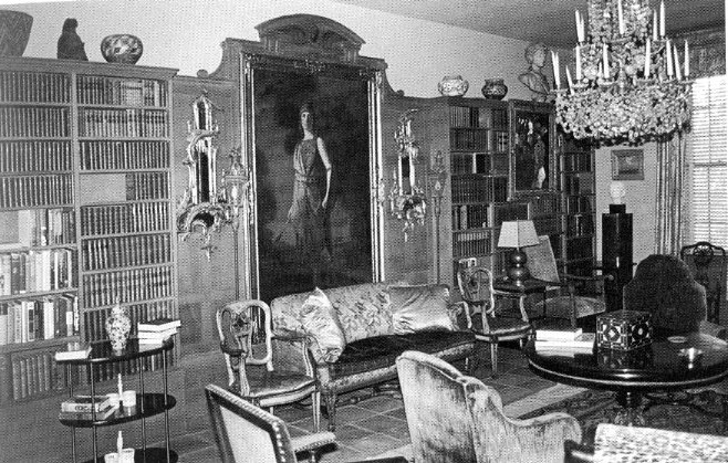 The New York Room of Amelia Elizabeth White and her sister Martha White became the library for resident scholar fellows in the first decades of the program. Today it is the Wagner scholar residence. Featured amidst the books is Martha White as an Amazonian warrior queen from Greek mythology in her painted senior portrait from Bryn Mawr in 1903. Photo courtesy of the School for Advanced Research.